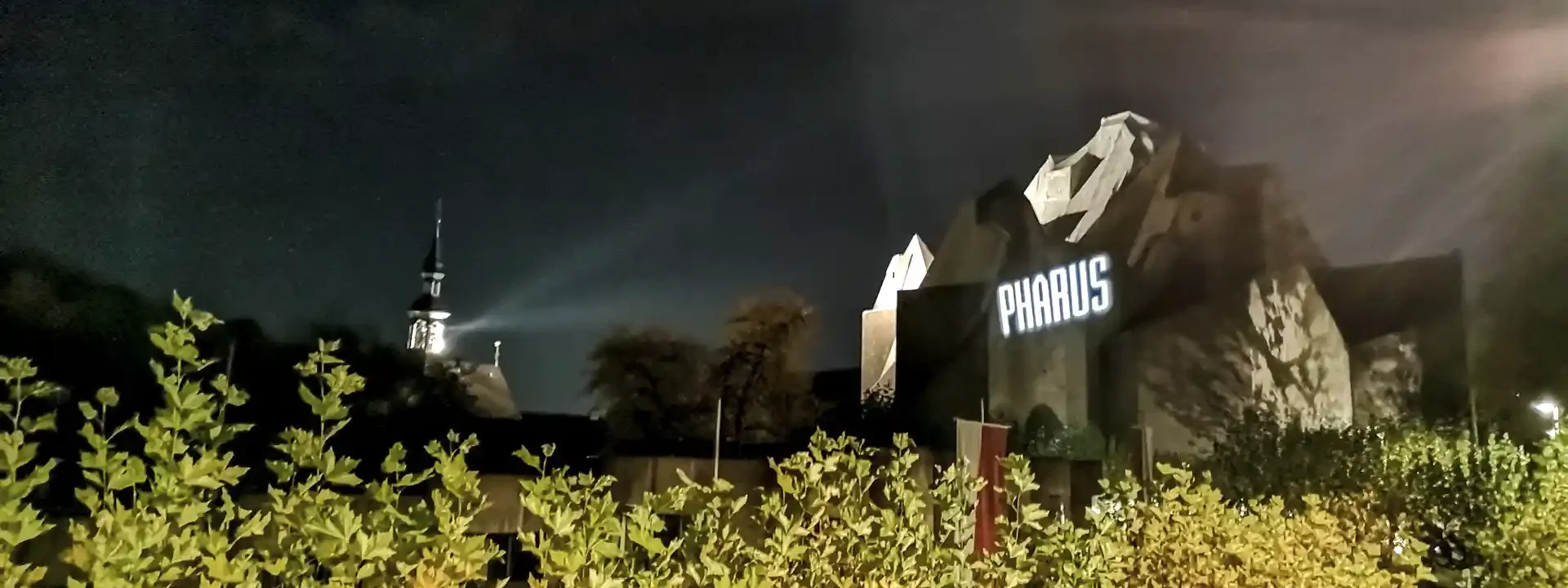 PHARUS lettering projected onto the Mariendom Neviges at night